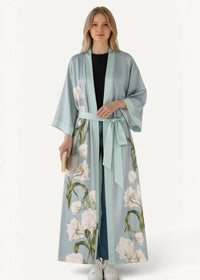 A light blue satin floral kimono robe with white flowers green stems wide sleeves and a matching waist belt
