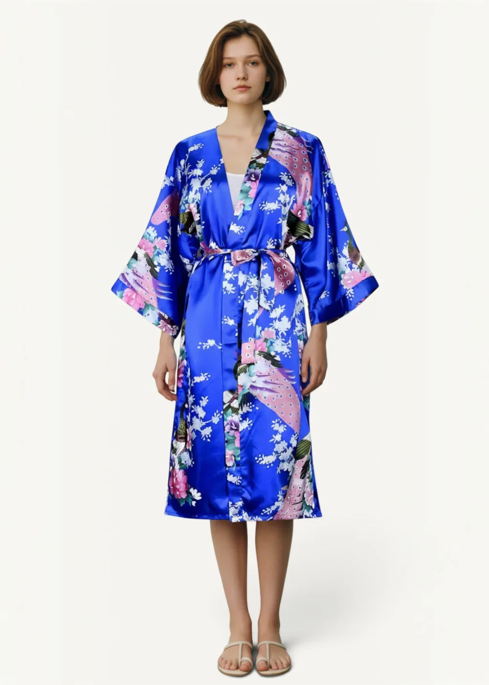 Floral satin kimono in vibrant blue with floral and peacock pattern featuring wide sleeves and a matching belt