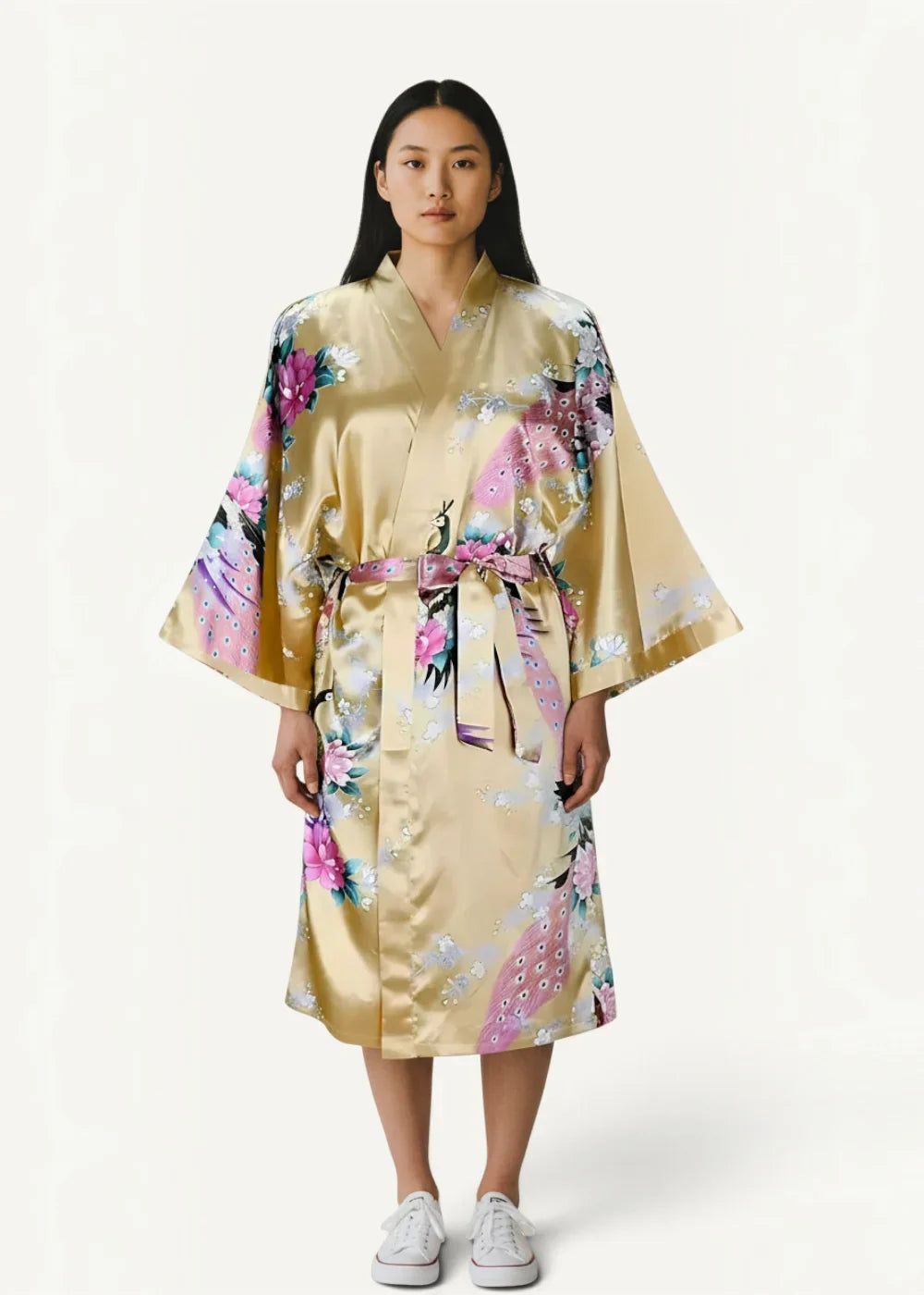 A shimmering gold satin floral robe with pink and purple patterns and a matching belt tied at the waist
