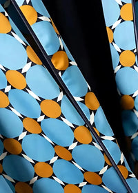 Geometric kimono set featuring vibrant blue and orange geometric patterned fabric with white accents on black background