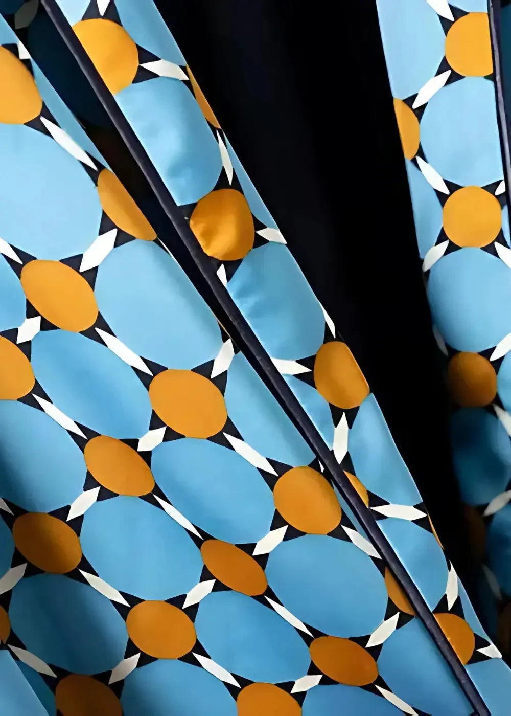 Geometric kimono set featuring vibrant blue and orange geometric patterned fabric with white accents on black background