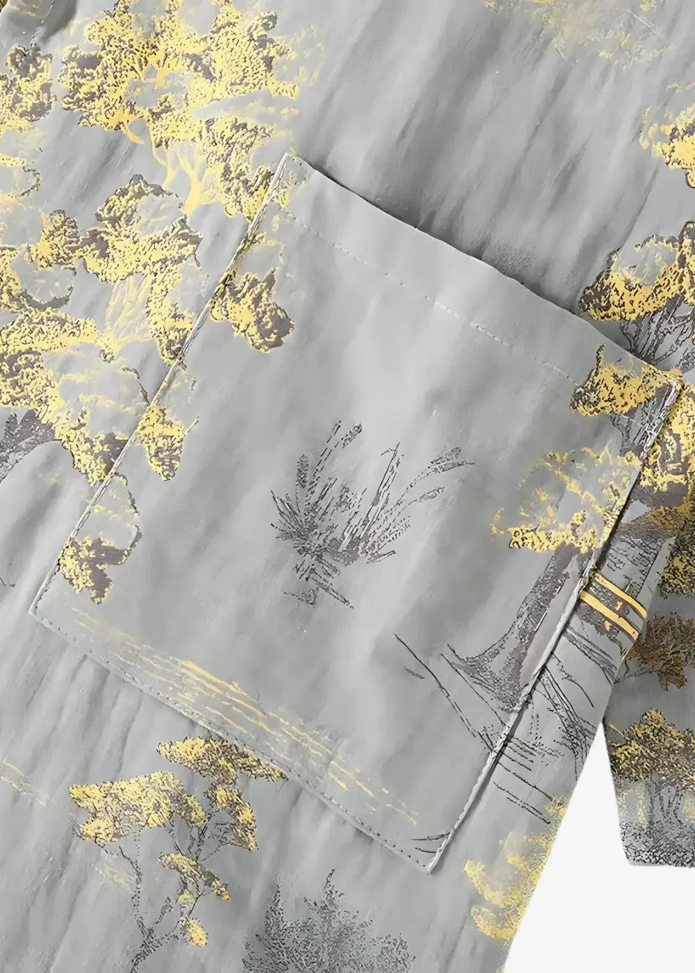 Gray kimono pajamas in fabric with subtle gold and black botanical print and an embroidered pocket detail