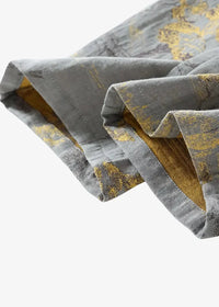Gray kimono pajamas with subtle gold leaf pattern and visible stitching along the folded hem of gray trousers