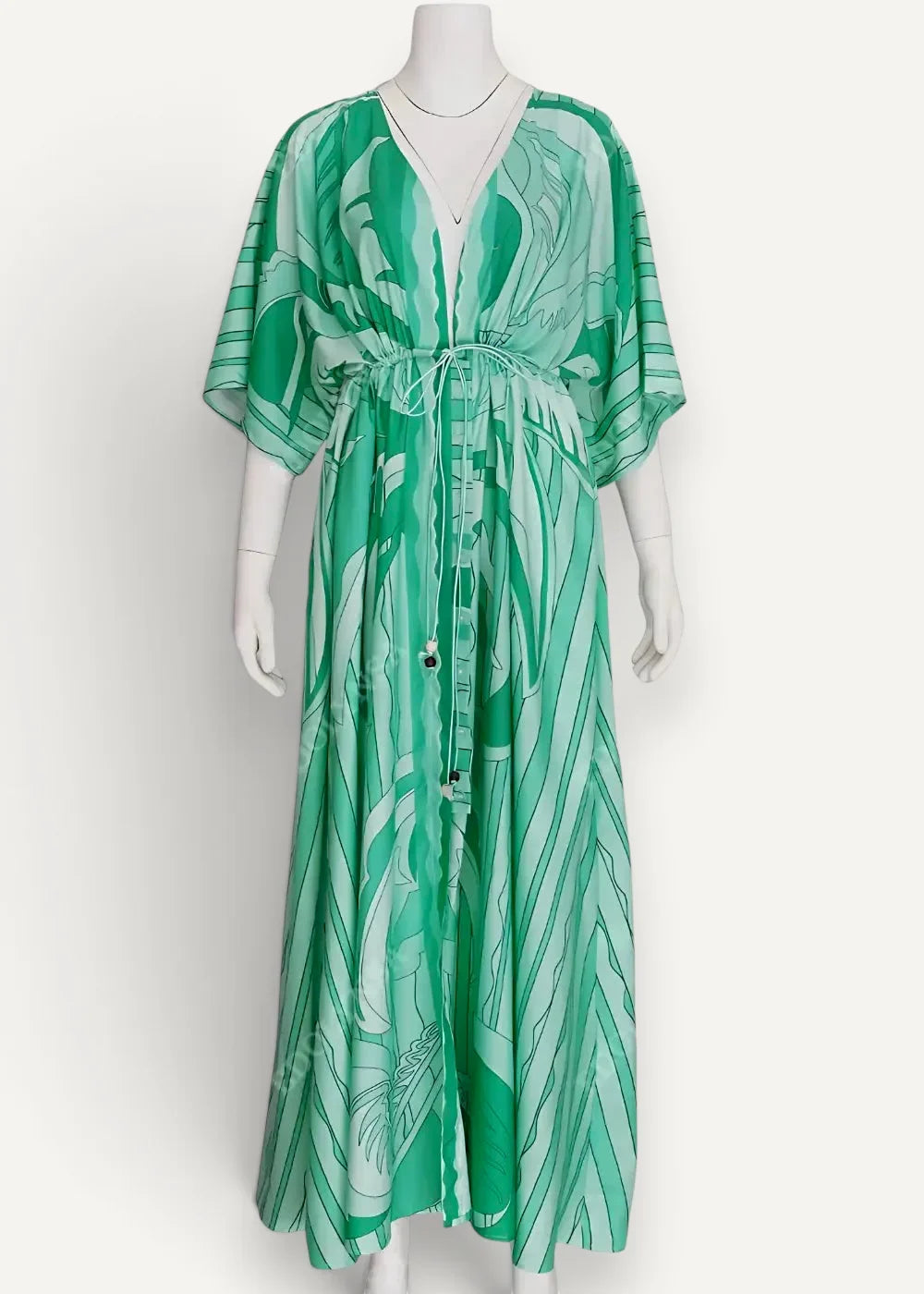 Green kimono maxi dress with flowing emerald green fabric tropical leaf pattern v-neckline and drawstring waist
