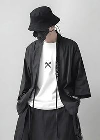 Man wearing the black haori coat open over a white tee, styled with a black bucket hat