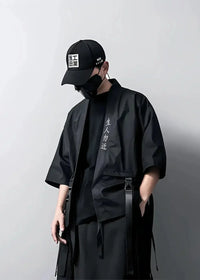 Black short-sleeved haori coat with vertical white embroidery and adjustable straps in a utility jacket style