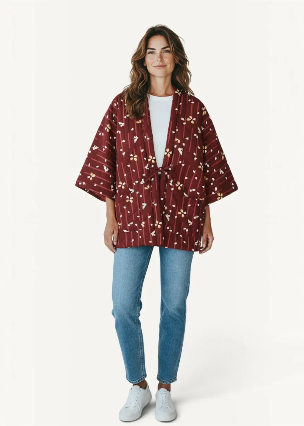 A maroon haori kimono female jacket with subtle floral and striped pattern made from soft fabric