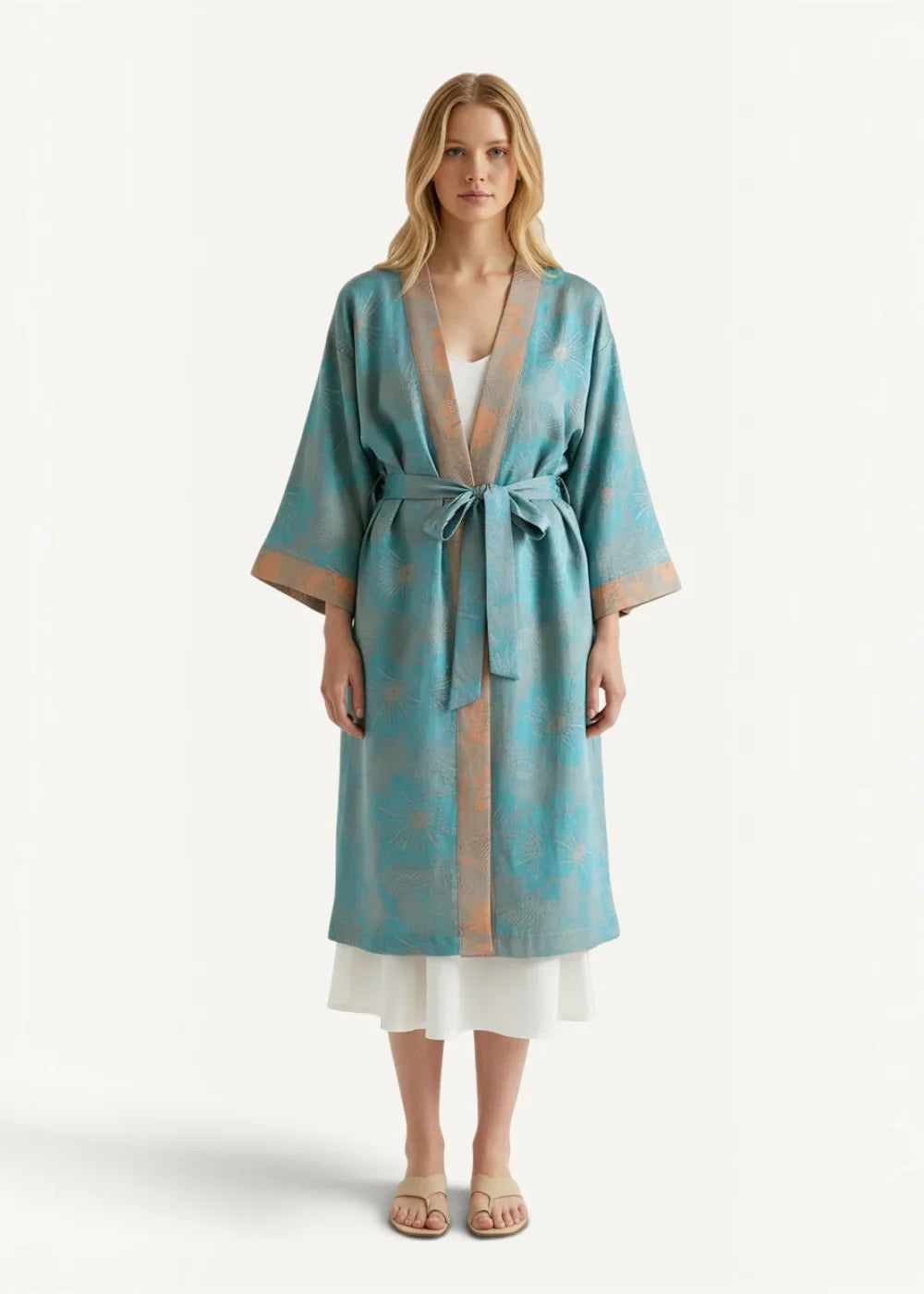Teal and gold patterned Japanese cotton kimono robe made of silk with a matching belt tied at the waist