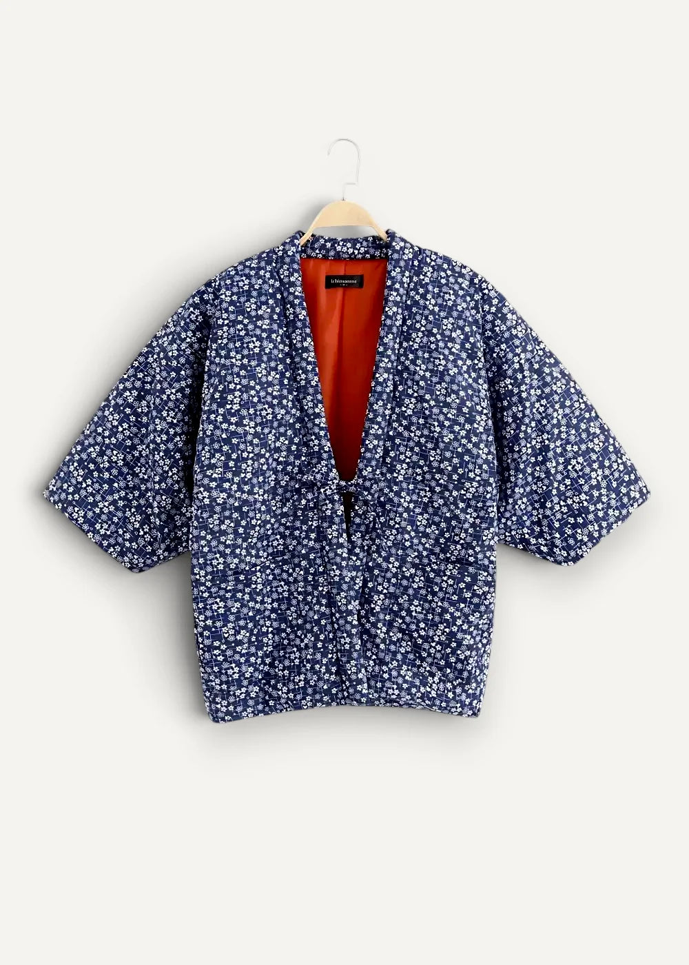 Blue floral-patterned quilted japanese haori jacket with vibrant orange interior lining for stylish layering