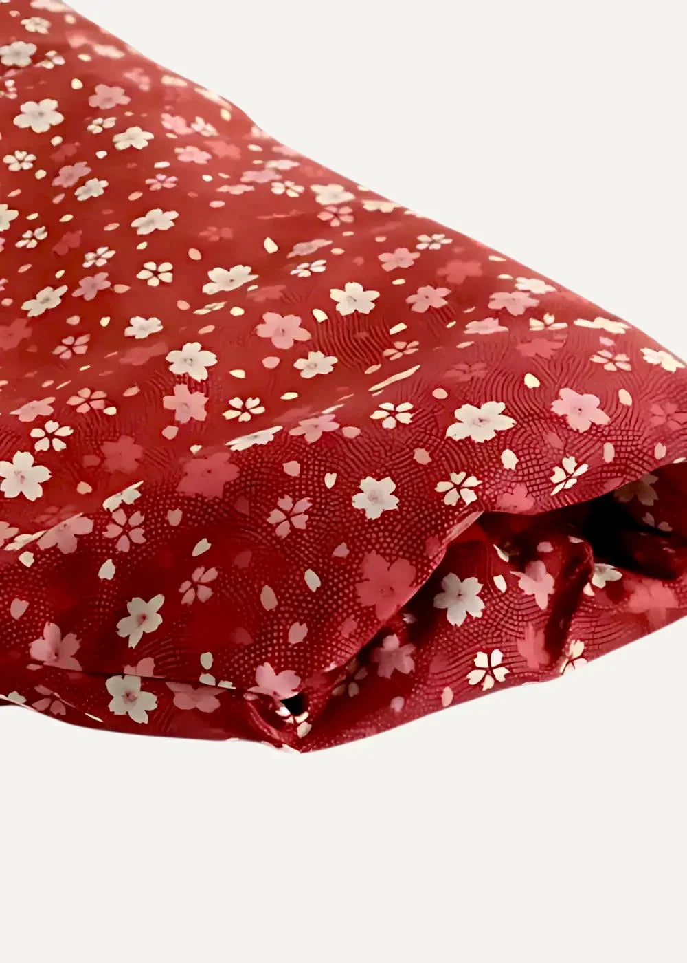Red fabric with delicate white and pink cherry blossom pattern on japanese haori jacket material