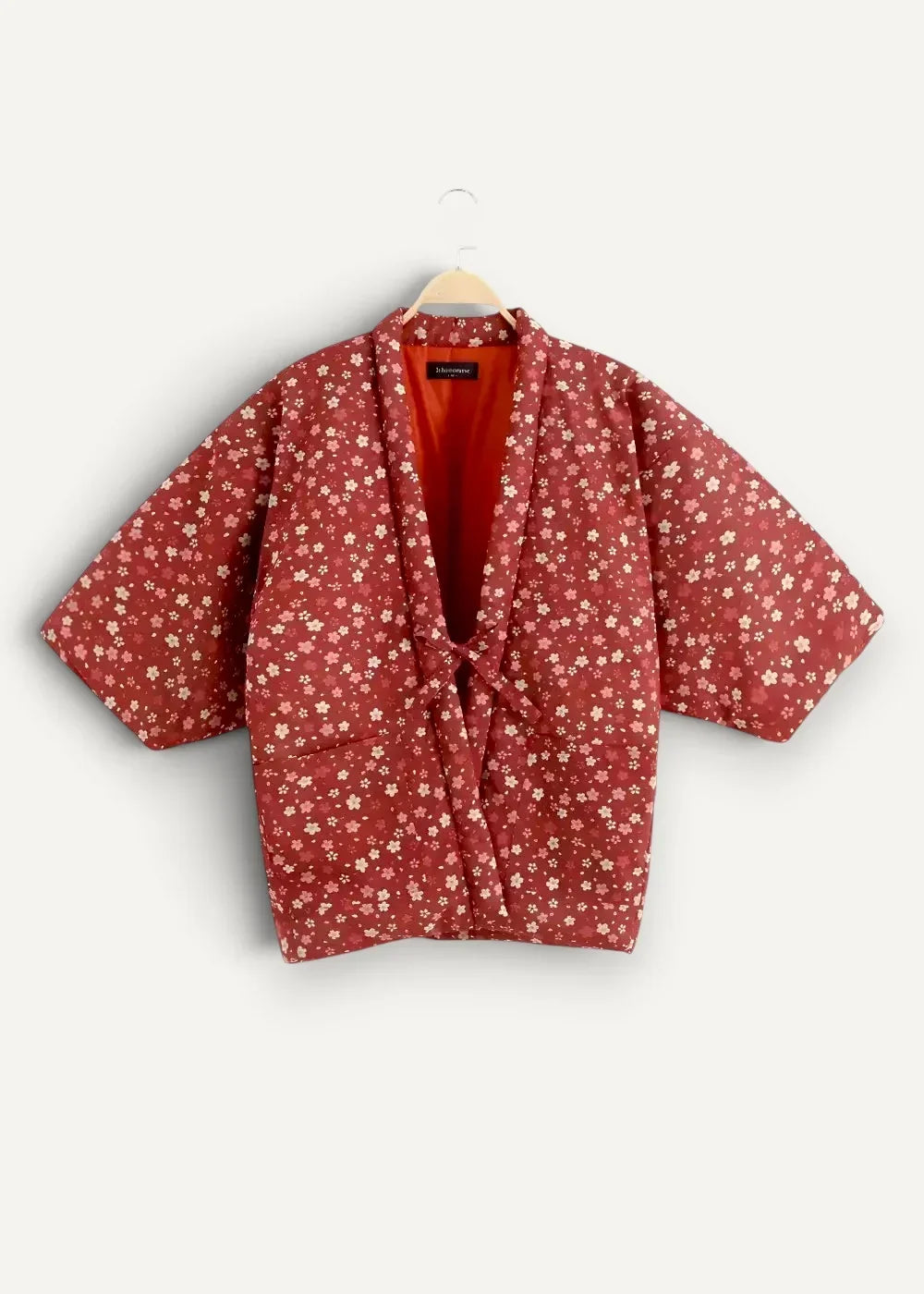 Japanese haori jacket red floral-patterned quilted fabric with vibrant orange interior lining for stylish layering