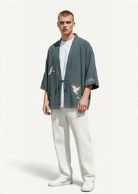 Dark green loose-fitting japanese haori kimono jacket with embroidered bird motifs on sleeves and front