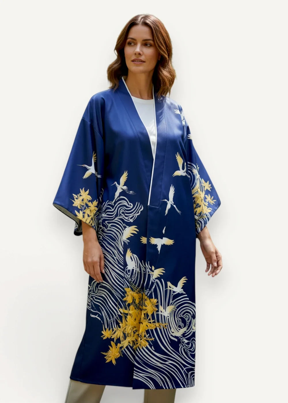 A navy blue silk Japanese kimono for females with white and gold crane motifs and swirling wave patterns