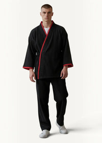 Black kimono pajamas jacket with red trim along collar cuffs and front opening in traditional Japanese style