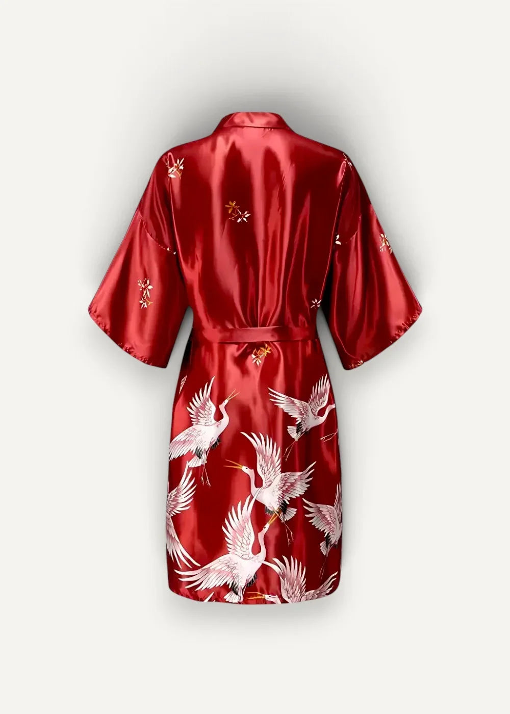 Red satin Japanese kimono robe female with white crane motifs and gold floral embroidery in vibrant design