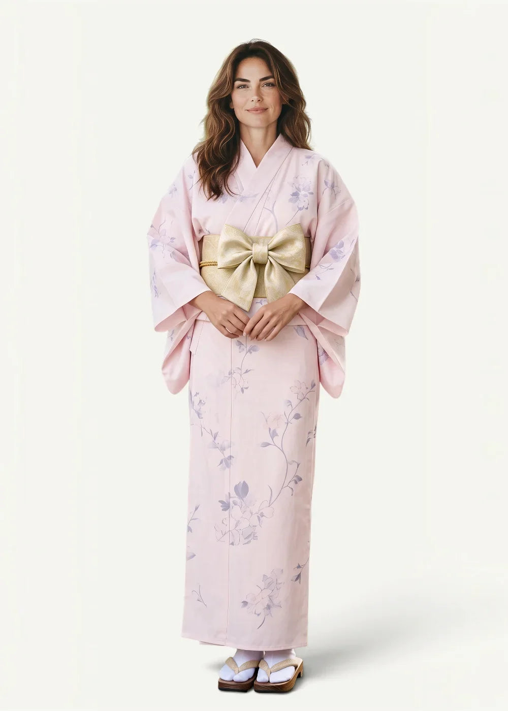 A delicate pink Japanese print kimono with lavender floral patterns and a wide gold obi sash tied in a bow