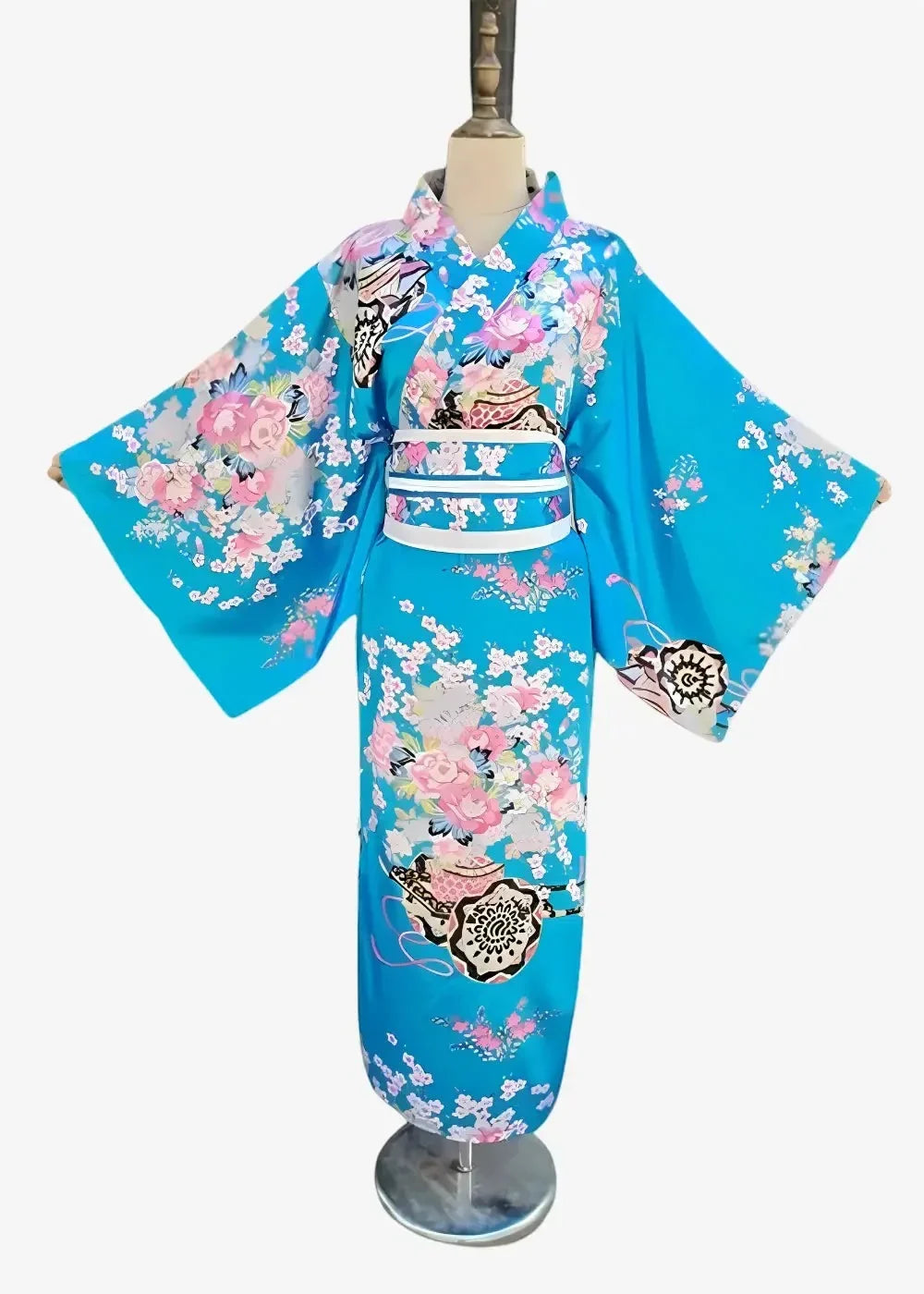 A vibrant turquoise Japanese satin kimono featuring intricate pink white and black floral and decorative motifs