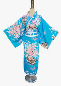 A vibrant turquoise Japanese satin kimono featuring intricate pink white and black floral and decorative motifs