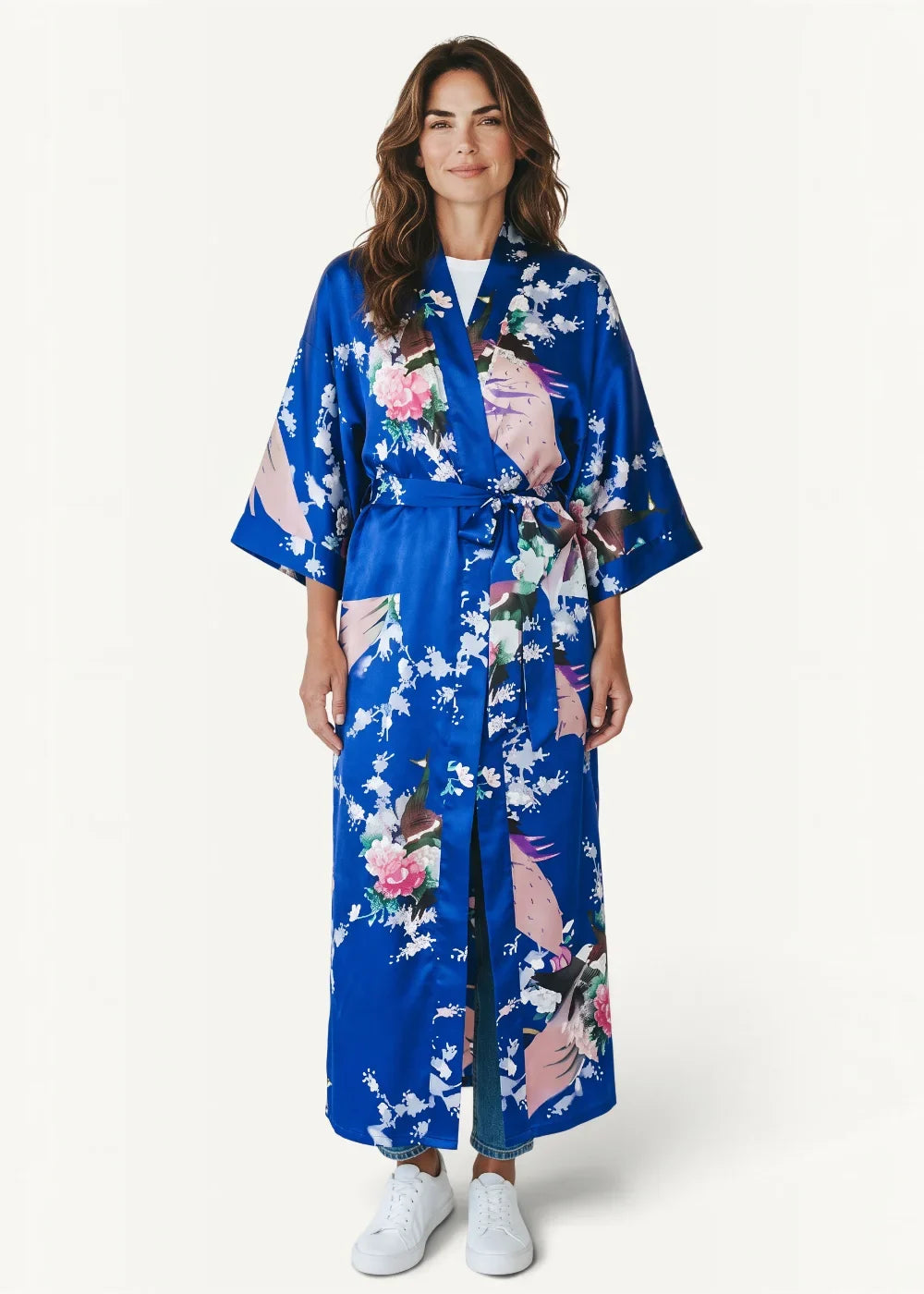 A vibrant royal blue Japanese silk robe with a delicate floral and bird pattern in soft pinks whites and greens