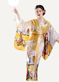 A woman wearing a vibrant yellow and white Japanese yukata with traditional figures floral patterns and pagodas