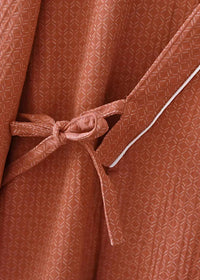 Kimono bathrobe men’s rust-colored with subtle geometric weave pattern white piping and fabric belt tied at waist