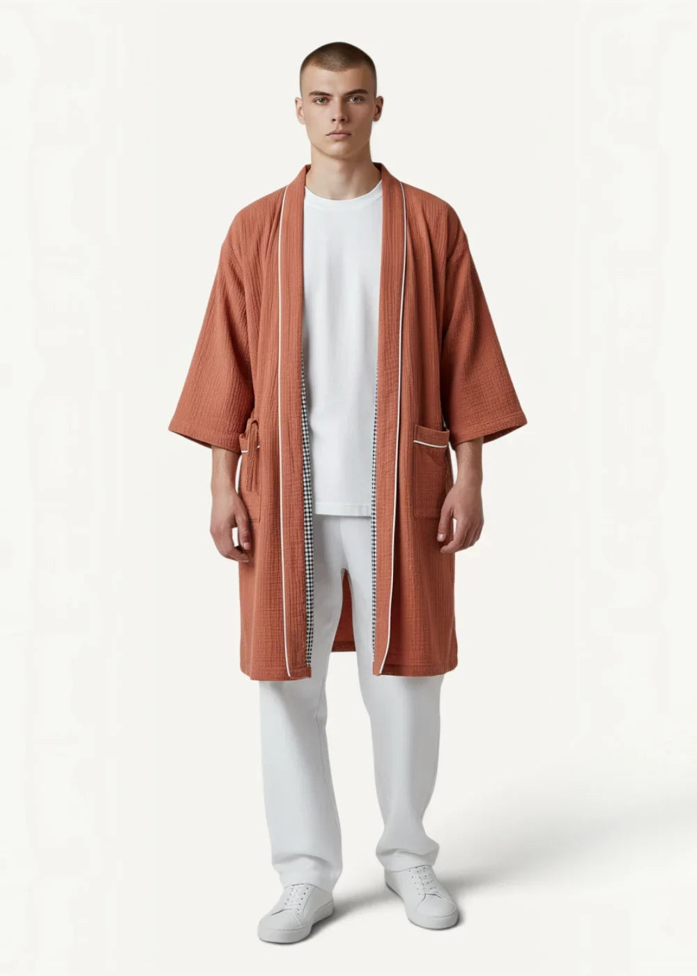 A terracotta textured cotton kimono bathrobe for men with white piping and subtle checkered zipper detail