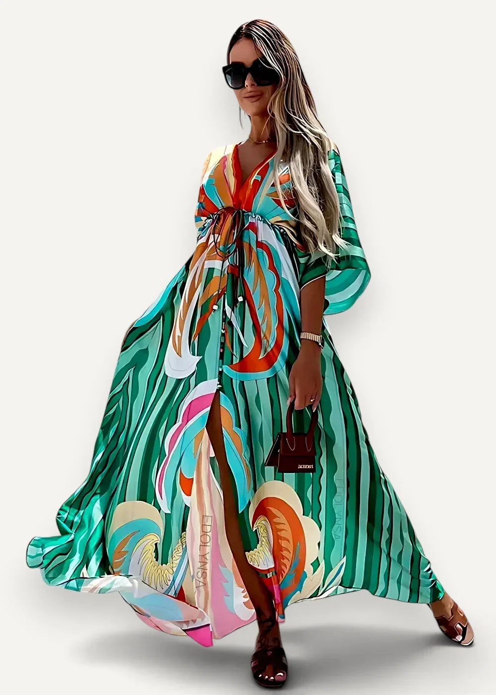 A flowing long-sleeved green kimono beach dress with bold teal orange and white abstract patterns