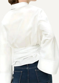 A white kimono cardigan short with long sleeves, cinched waist, and voluminous fabric for stylish layering