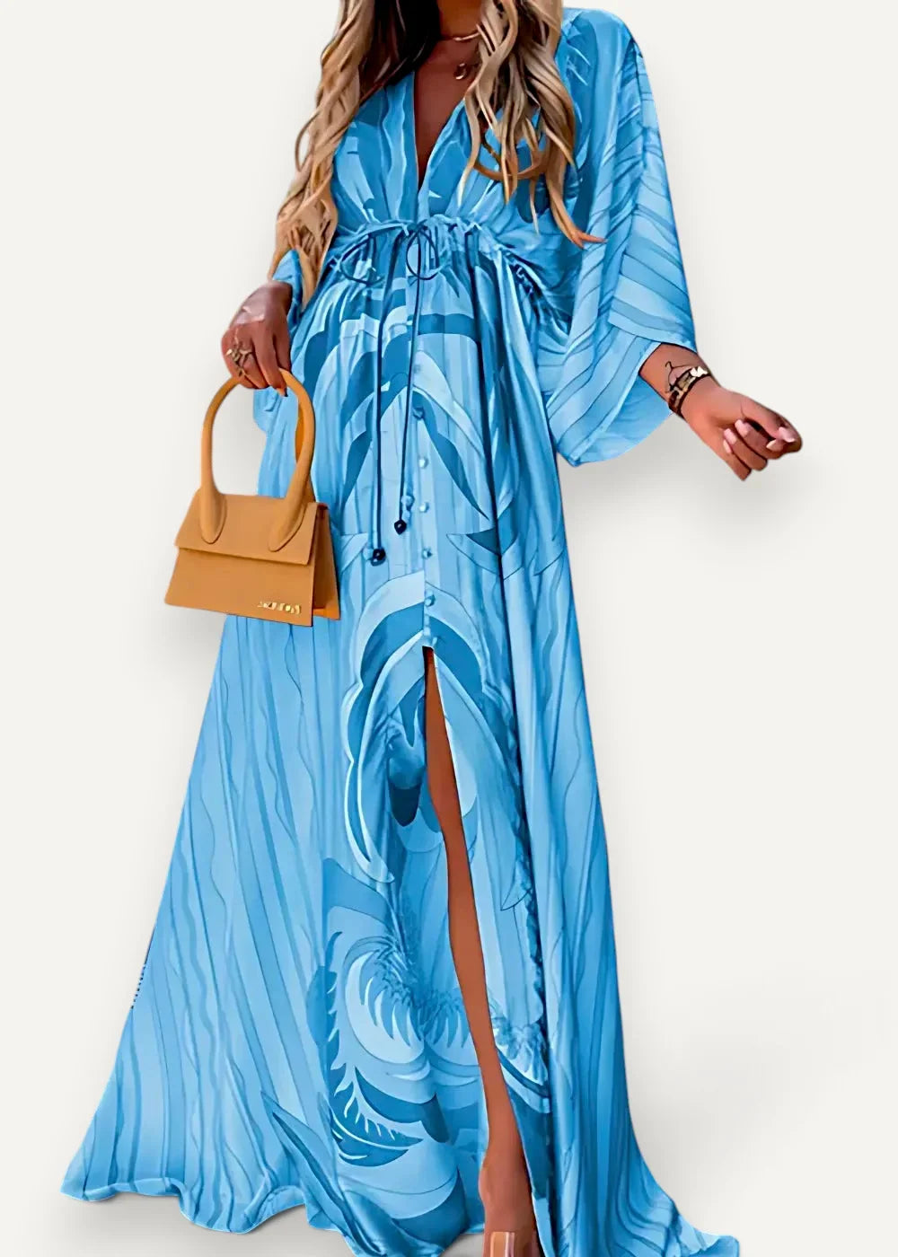 A flowing light blue kimono cover up dress with bold abstract leaf pattern and wide billowing sleeves