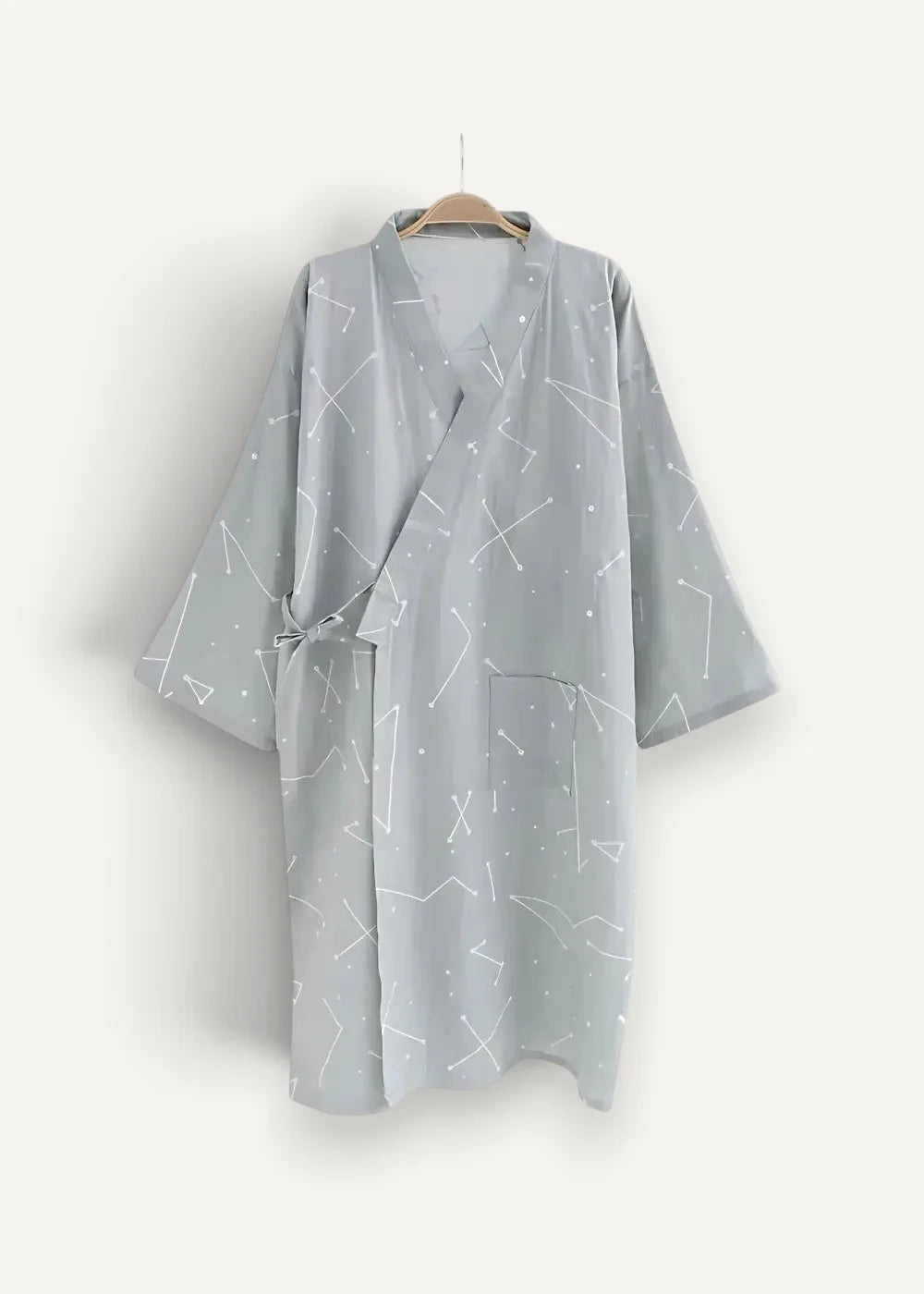 A light gray cotton kimono dressing gown with a white constellation pattern v-neckline and tied waist
