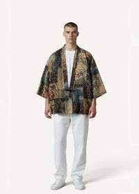A man wearing a patchwork earth-toned kimono haori jacket with intricate floral and geometric designs