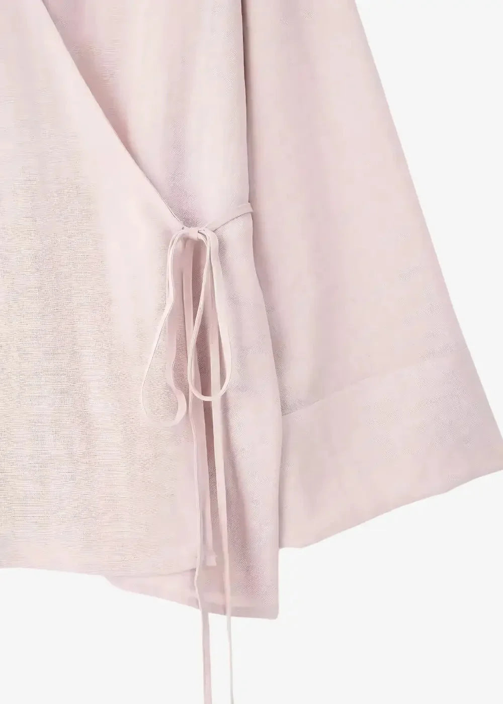 A soft blush pink kimono linen wrap dress with lightweight textured fabric and a delicate self-tie belt at the waist