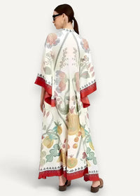 Kimono maxi dress in flowing off-white fabric with vibrant pink green yellow and red botanical fruit print and red trim