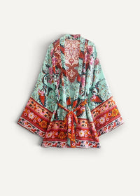 Kimono mini dress with vibrant mint green and red floral print and decorative belt tied at the waist