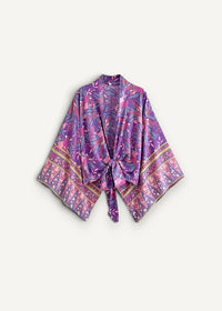 A flowing purple and pink patterned silk kimono with intricate floral designs and gold-trimmed cuffs in a kimono pants set