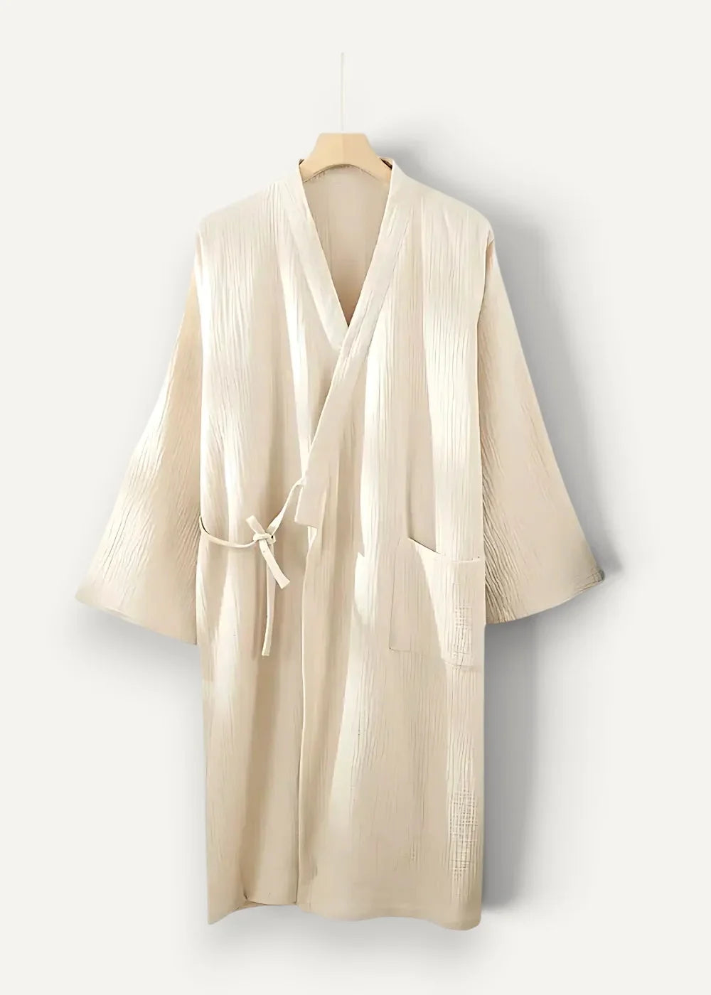Cream-colored kimono robe dressing gown made of textured fabric with v-neckline and matching tie belt