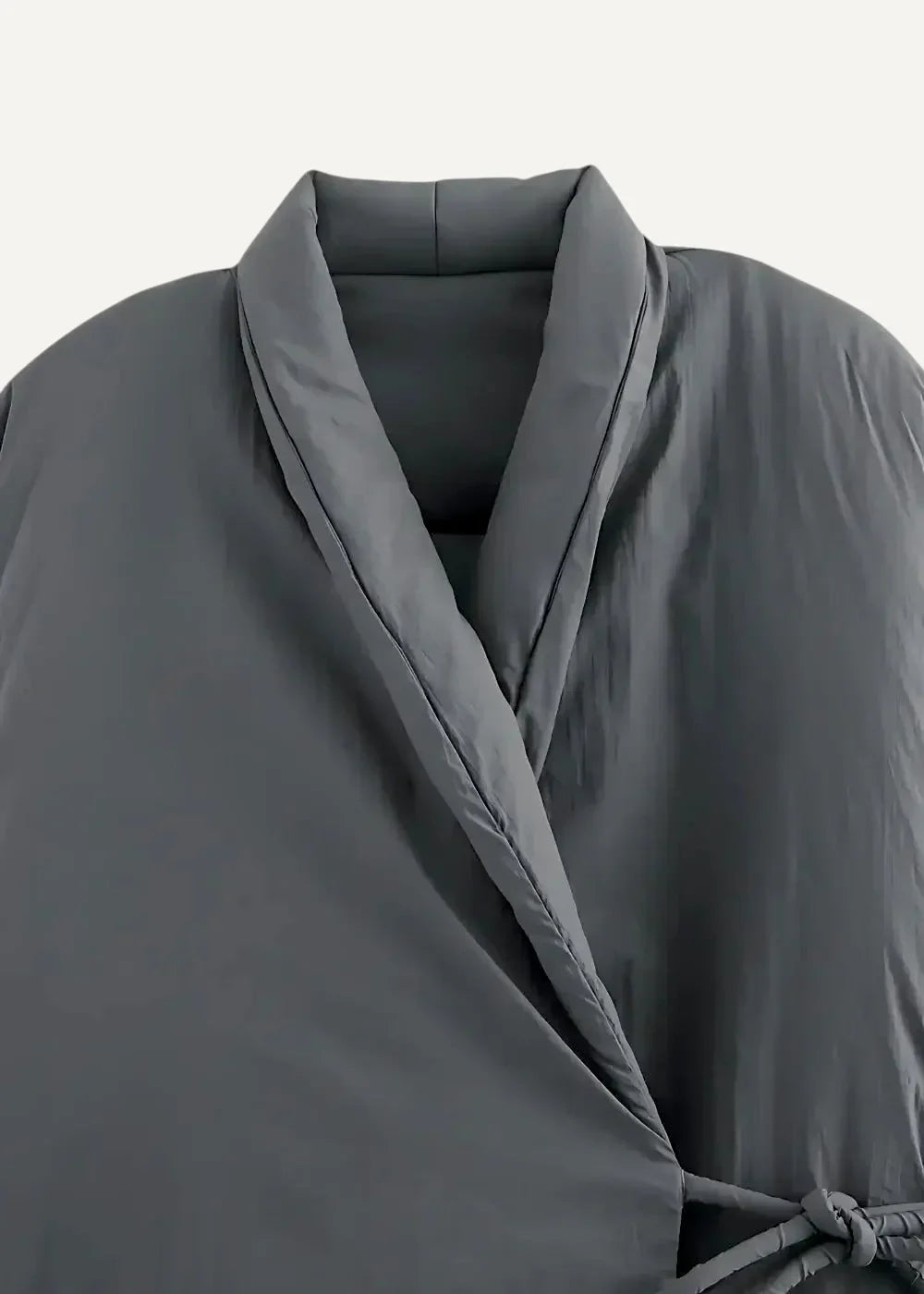 A sleek dark gray quilted kimono style coat with a structured collar and matching tie belt