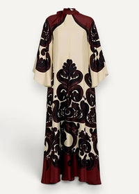 Kimono style dress long with flowing cream and deep burgundy fabric featuring intricate black ornamental pattern