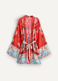 A vibrant red kimono style dress short with a matching tie belt and intricate pink and blue floral patterns along the hem