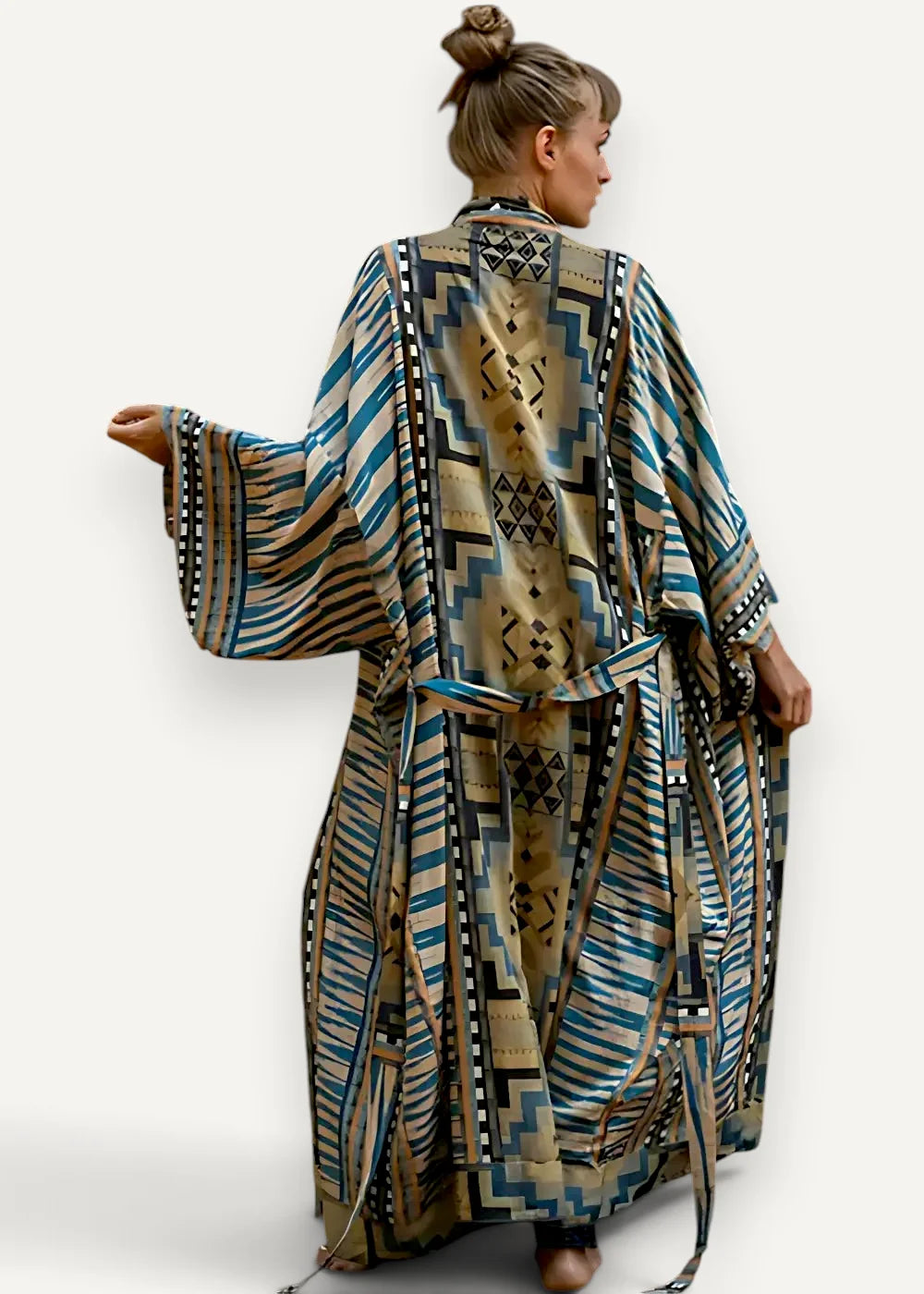 A flowing long sleeved kimono style maxi dress in earthy beige with bold teal blue and black geometric patterns