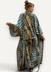 A flowing long sleeved kimono style maxi dress in earthy beige with bold teal blue and black geometric patterns