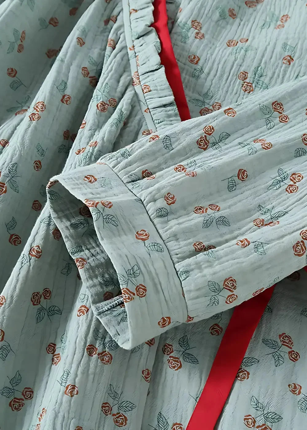 Light blue cotton kimono style pajamas with rust orange rose leaf pattern and red ribbon neckline accent