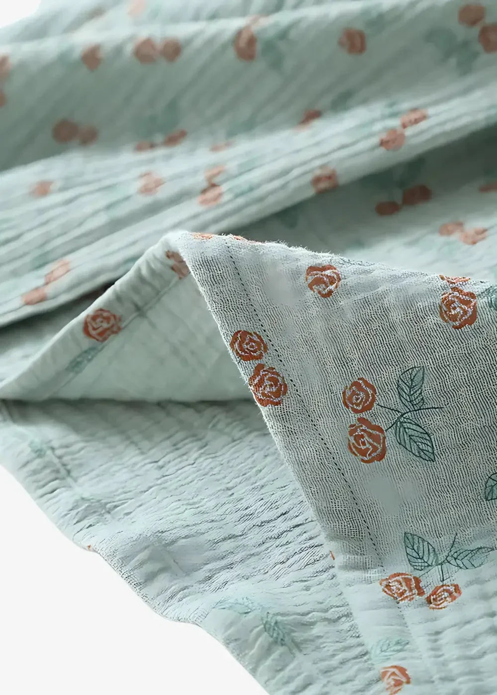 Light blue gauze kimono style pajamas with rust-colored rose and green leaf pattern on soft fabric