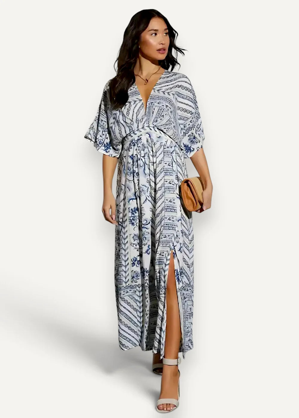 A flowing long-sleeved kimono summer dress in white and navy blue geometric pattern with floral accents