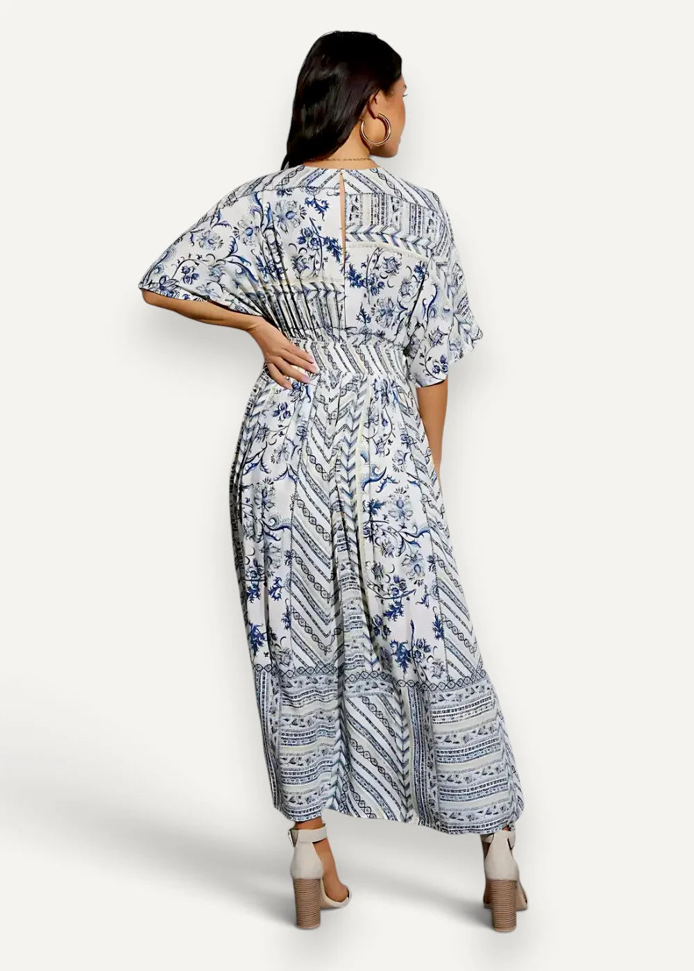 White kimono summer dress with blue floral patterns short flutter sleeves and back slit in flowing maxi style