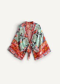 A light green floral kimono swim cover up with vibrant orange and pink accents tie front and wide sleeves