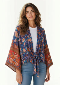 A vibrant kimono top with a flowing design featuring a rich blue base and intricate orange pink brown floral patterns