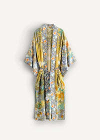 Kimono wrap cover up with flowing long sleeves and vibrant yellow green and orange floral pattern with matching belt