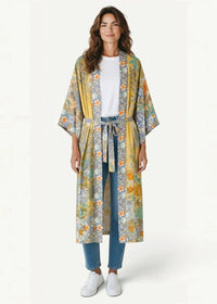 A flowing long-sleeved kimono wrap cover up with vibrant yellow and muted green floral pattern and gray accents