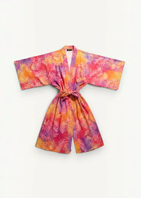 A vibrant kimono wrap dress maxi with short sleeves and tropical leaf pattern in pink orange and purple shades